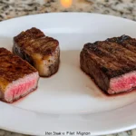 Flat iron steak vs filet mignon on a wooden board.